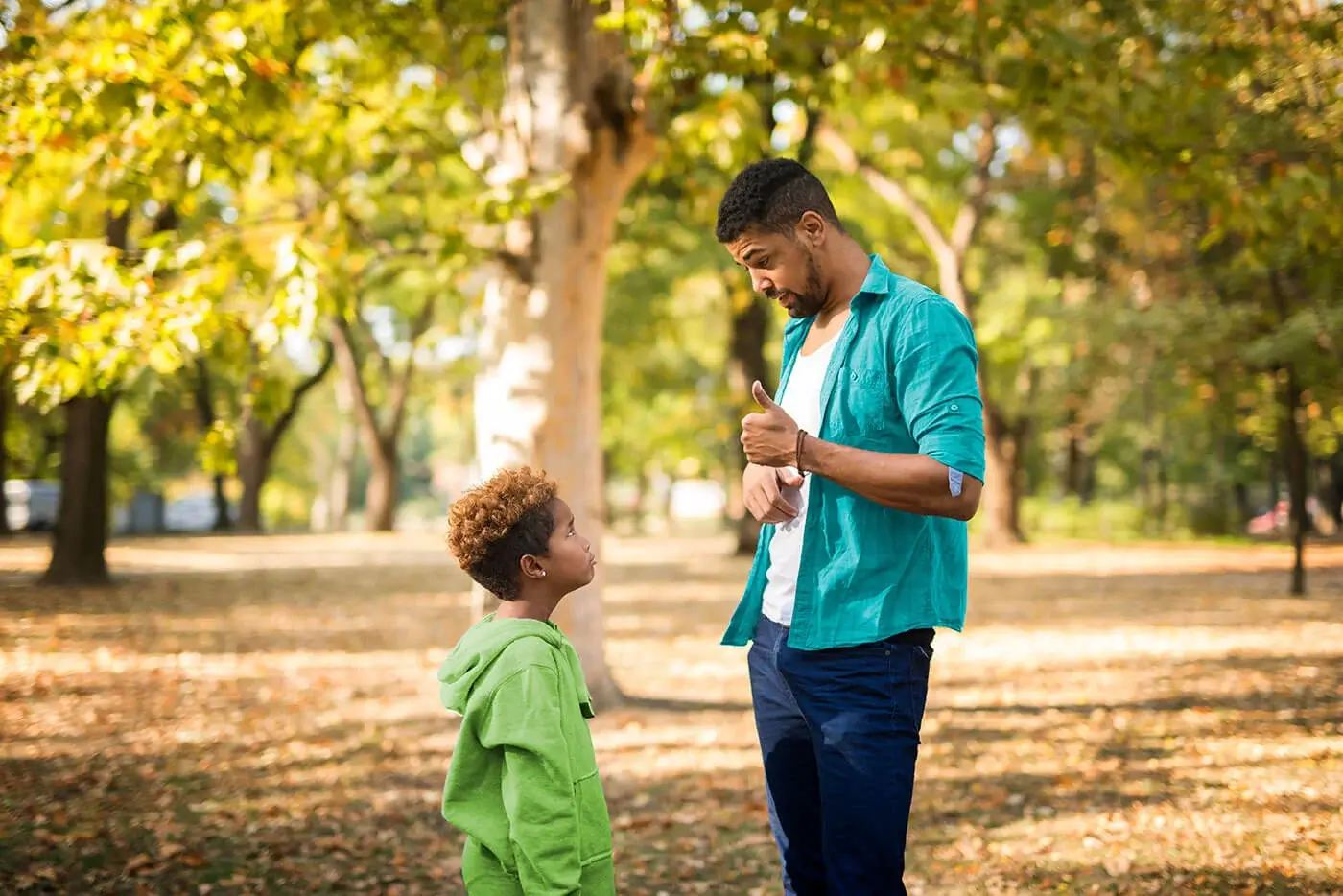 A man having a serious conversation with a young boy.